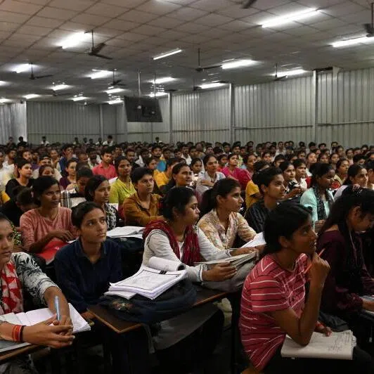 Students attend a class at a coaching institute training students to secure government jobs, in Prayagraj, India.