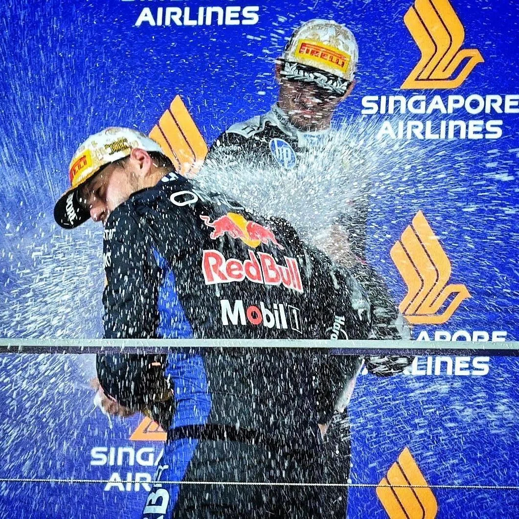 Red Bull’s Max Verstappen and Ferrari’s Charles Leclerc celebrate on the podium at the Singapore Grand Prix on Oct 11.
