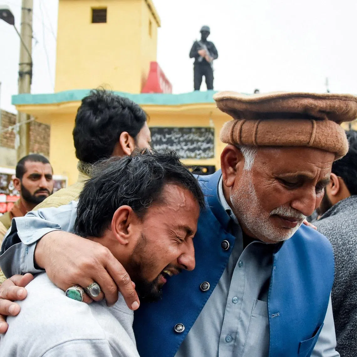 A man reacts while being comforted, after a deadly explosion at a Shi'ite Muslim mosque in Islamabad, Pakistan, February 6, 2026. REUTERS/Waseem Khan