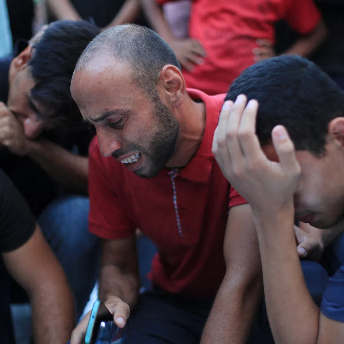Mourners react after Palestinians were killed in an Israeli strike on a cafe, at Al-Shifa hospital in Gaza City August 18, 2026. REUTERS/Dawoud Abu Alkas