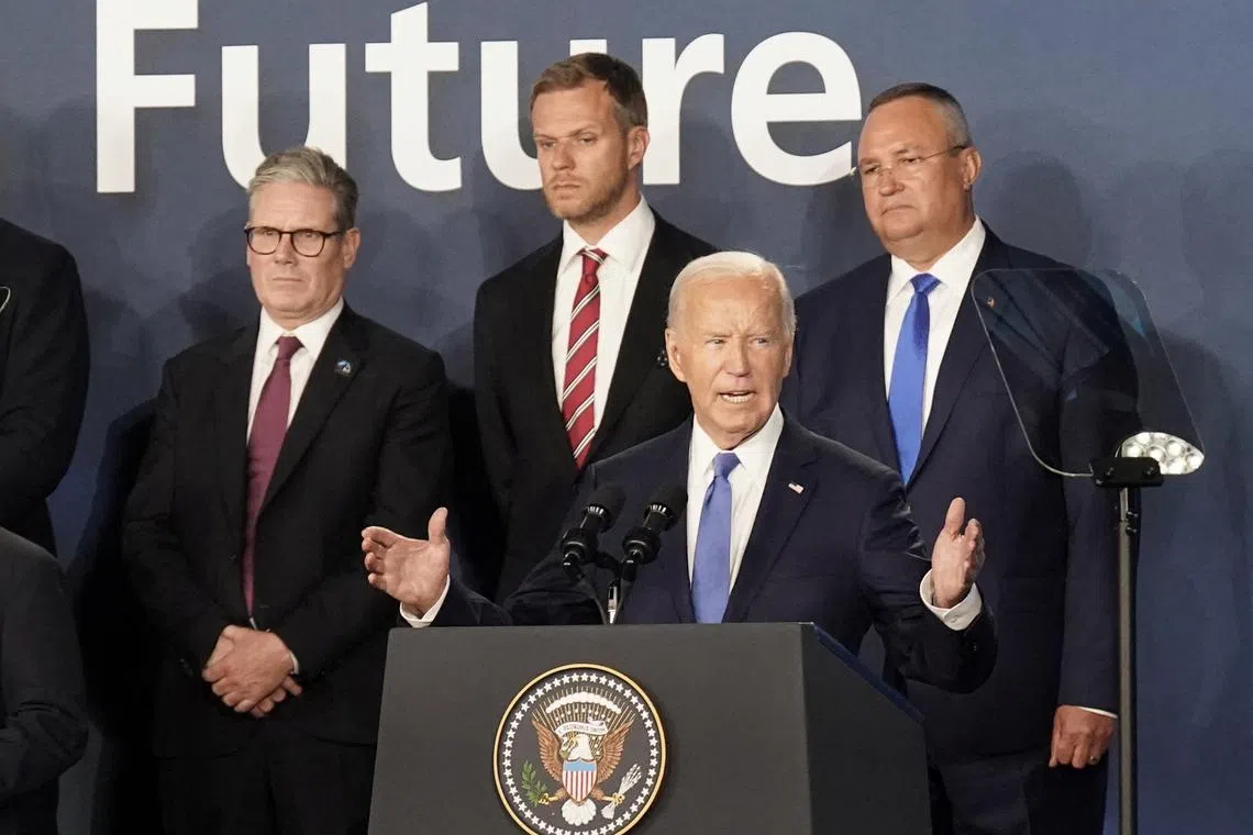 FILE PHOTO: Prime Minister Sir Keir Starmer (left) looks on as US President Joe Biden speaks, where he introduced Ukrainian president Volodymyr Zelenskiy as \"President Putin\" during the closing ceremony, at the Nato 75th anniversary summit at the Walter E. Washington Convention Center, in Washington DC, US. Picture date: Thursday July 11, 2024.  Stefan Rousseau/Pool via REUTERS/File Photo
