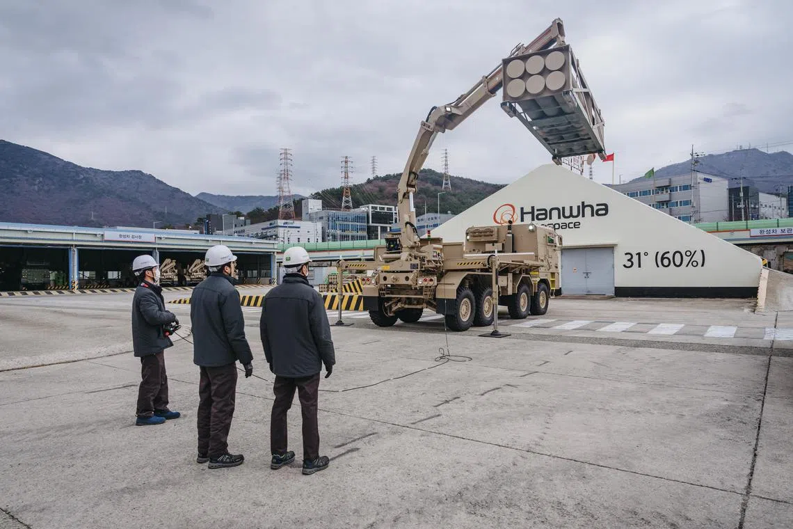 Hanhwa Aerospace engineers look on as a support vehicle unloads a multiple-rocket container during a test run at the factory in Changwon, South Korea on Feb. 16, 2023. Traditional weapons suppliers like the United States have faced production shortages in the war effort. South Korea has stepped in to fill the gap, without provoking Moscow. (Jun Michael Park/The New York Times)