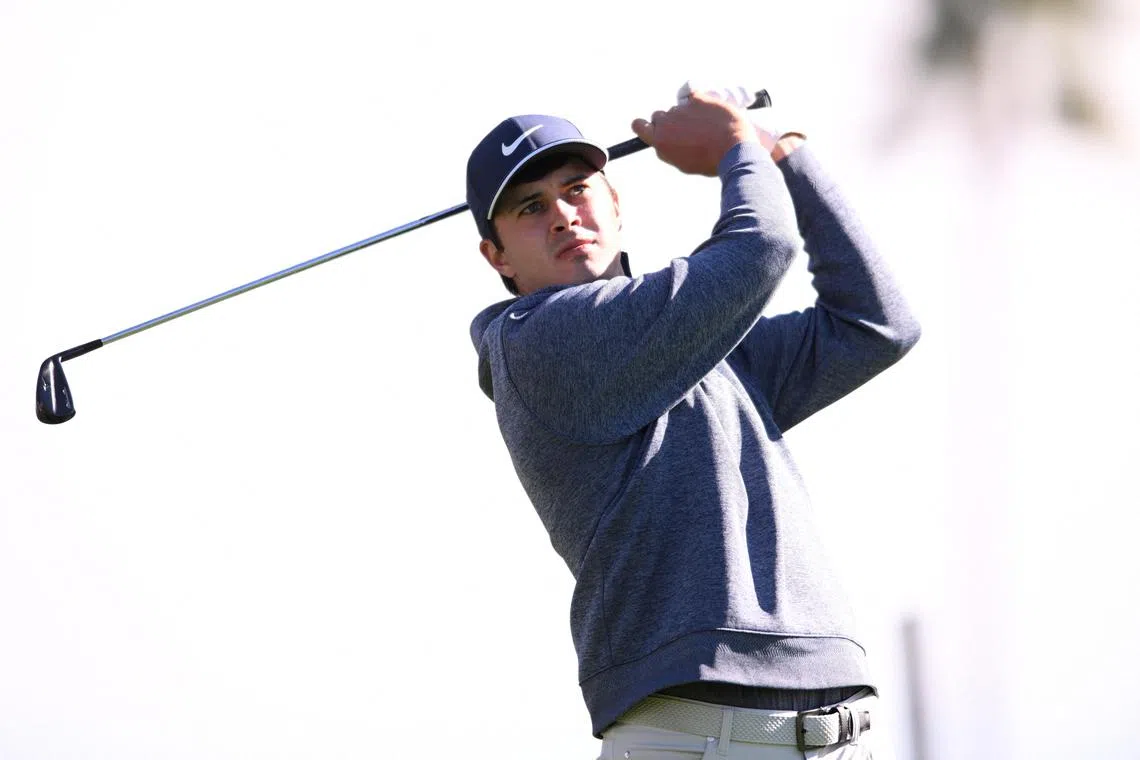 Davis Thompson plays his shot from the ninth tee during the first round of the American Express Tournament.