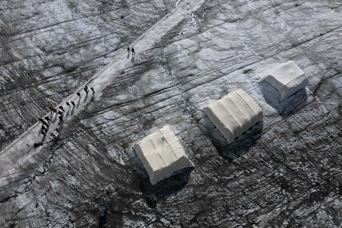 A drone view shows a snow protection test site covered with sheep wool material during a press conference presenting the results of the "Keep It Wool" glacier protection experiment in Les Diablerets, Switzerland, September 2, 2026. The project tested wool coverings on the Tsanfleuron Glacier at Glacier 3000 as a biodegradable alternative to synthetic geotextiles used in snowfarming to help slow glacier melt. Much of the wool produced in Switzerland is not commercially used and is often discarded, composted or incinerated. REUTERS/Denis Balibouse TPX IMAGES OF THE DAY