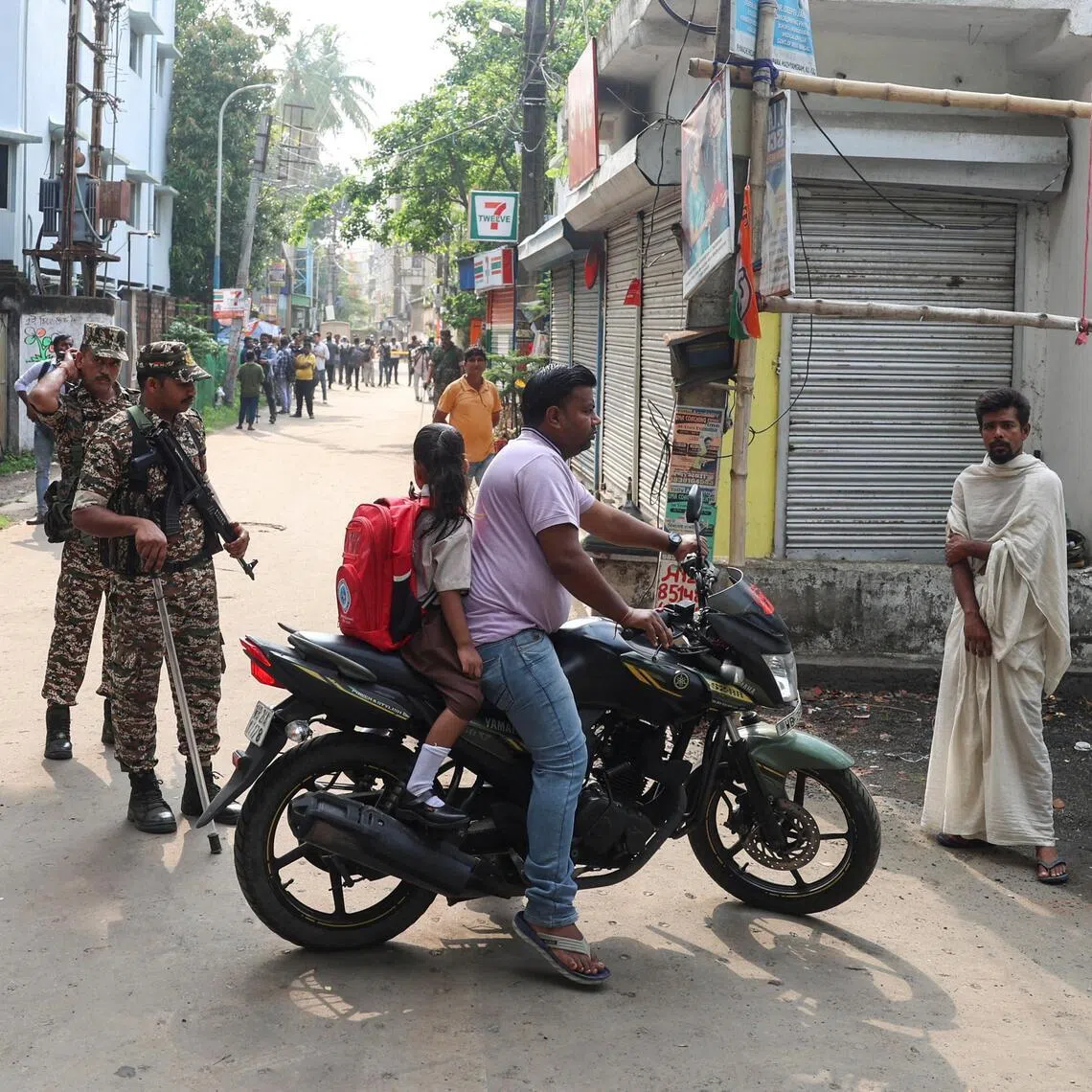 Security forces guard a road leading to the site where an aide of Bharatiya Janata Party (BJP) leader in West Bengal state Suvendu Adhikari was shot dead days after the BJP secured a majority in the state assembly elections.
