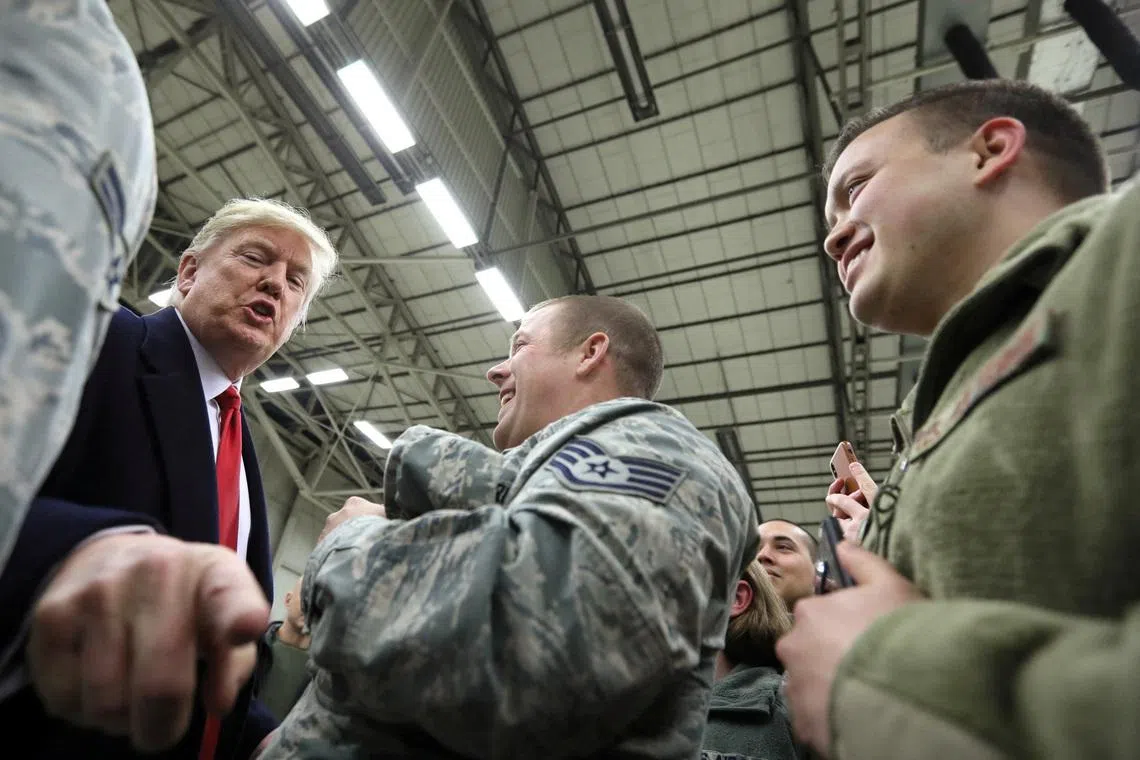 FILE PHOTO: U.S. President Donald Trump gestures as he visits U.S. troops at Ramstein Air Force Base, Germany, December 27, 2018. REUTERS/Jonathan Ernst/File Photo