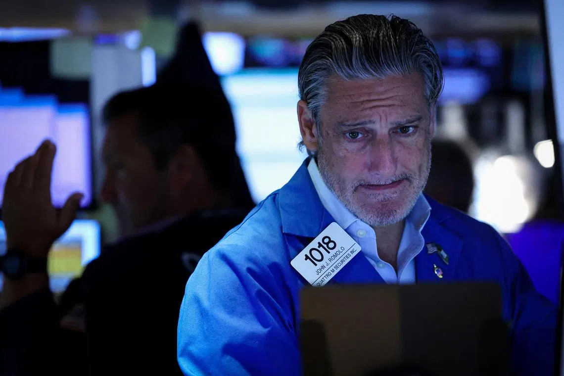 Traders work on the floor of the New York Stock Exchange, in New York City.
