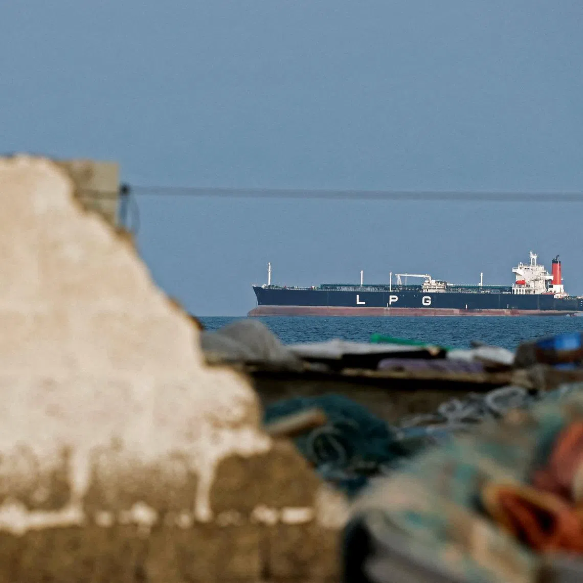 An LPG gas tanker at anchor as traffic is down in the Strait of Hormuz, amid the U.S.-Israeli conflict with Iran, in Shinas, Oman, March 11, 2026. REUTERS/Benoit Tessier
