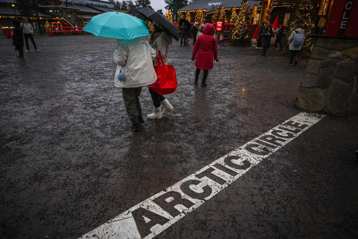 Tourists visit the Santa Claus Village during a rainy day, on Nov 16.