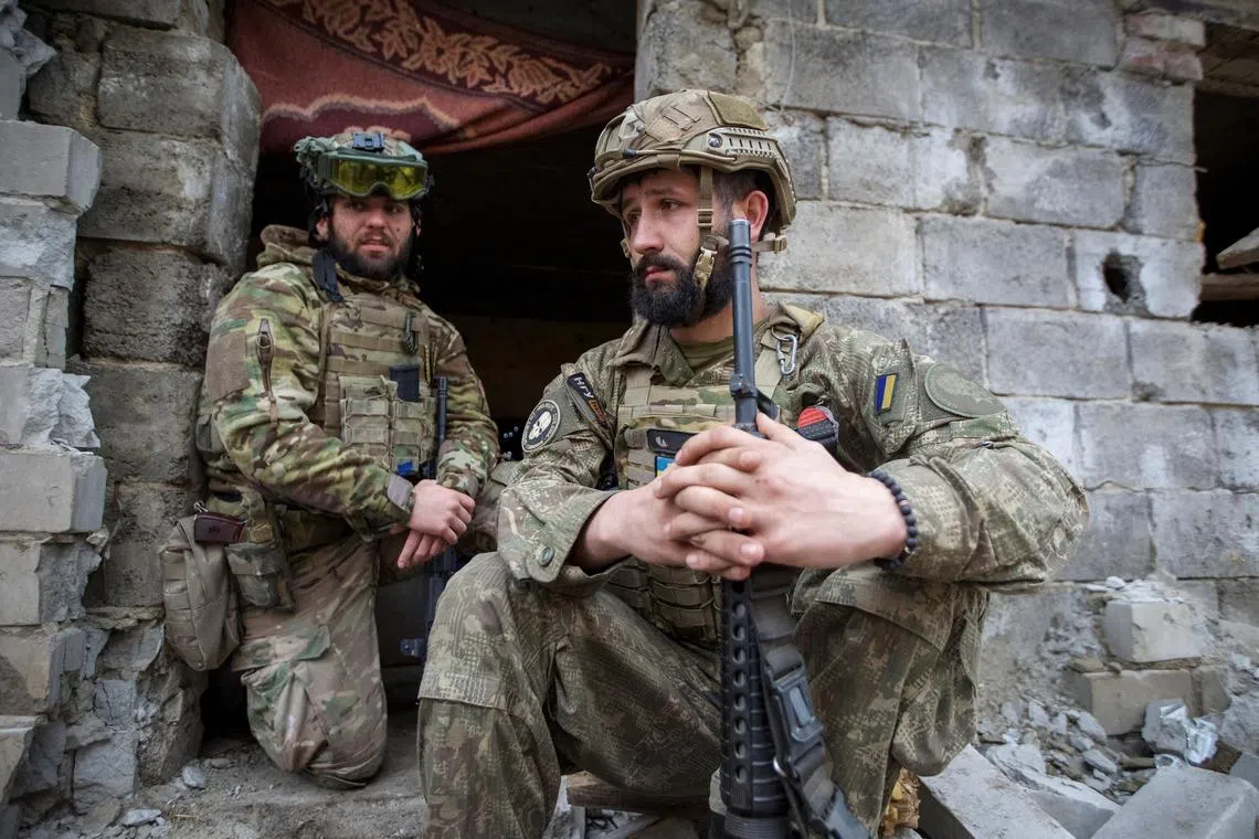 Ukrainian servicemen rest near their position, near the front-line town of Bakhmut.
