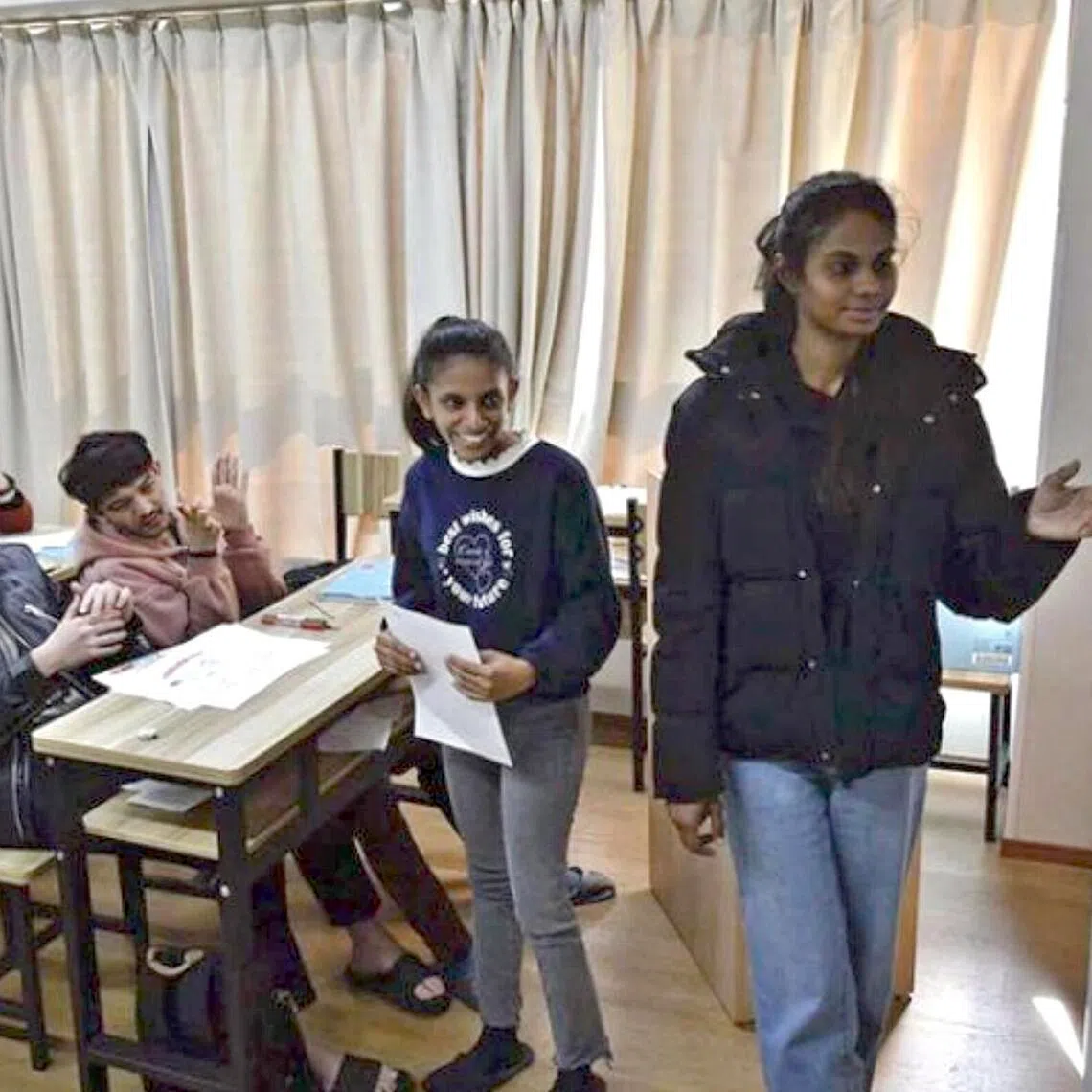 A foreign student gives a speech in Japanese at New World International Academy in Nagoya on Feb 18..