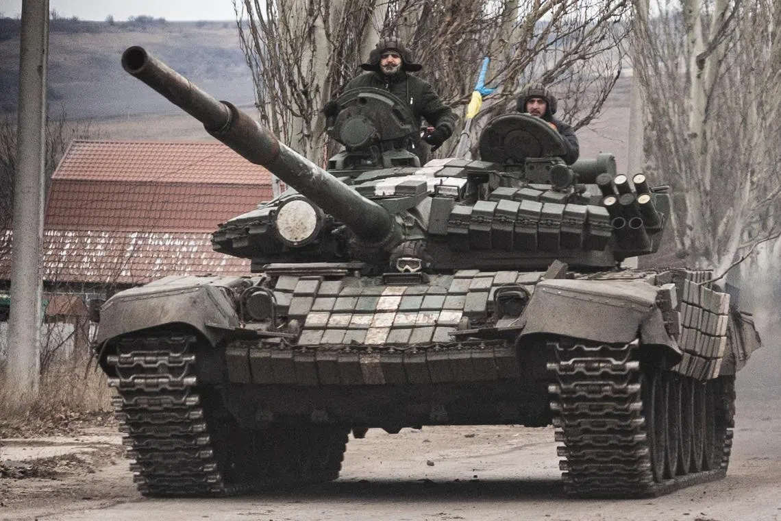 Ukrainian soldiers drive a T-72 tank on the outskirts of Bakhmut, eastern Ukraine, in December 2022.
