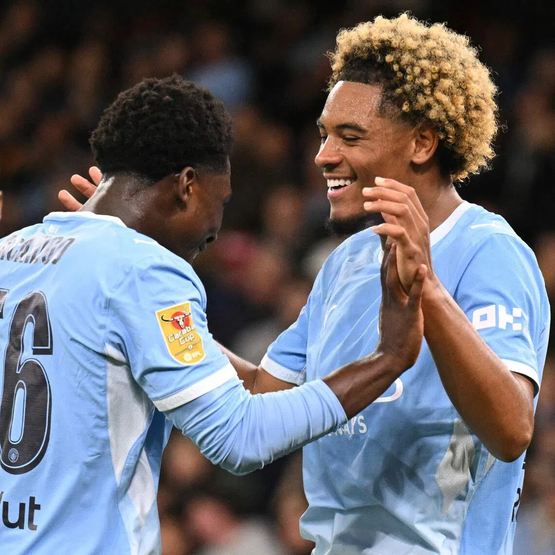 Manchester City’s French midfielder Floyd Samba (right) celebrates scoring the team’s fourth goal against Norwich City on Sept 17, with teammate Ryan McAidoo.