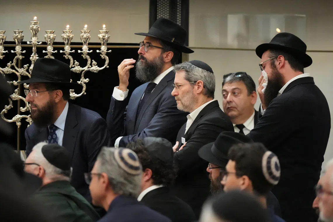 Mourners gather at a synagogue for the funeral of Rabbi Eli Schlanger, a victim of a mass shooting during a Jewish Hanukkah celebration on Sydney’s Bondi Beach, on Dec 17.