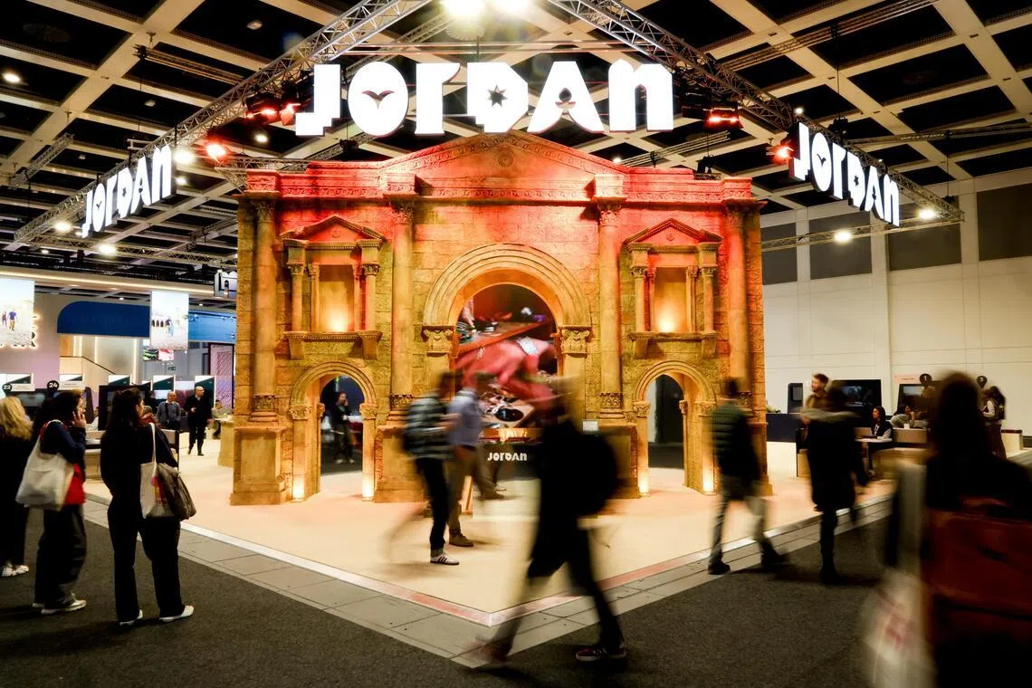 Visitors pass by the Jordan booth at the International Travel Trade Show 2026 (ITB) in Berlin.