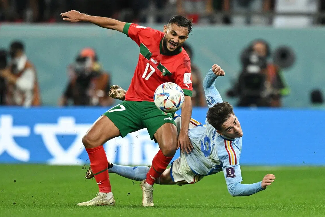 Morocco's Sofiane Boufal in action with Spain's Gavi in the Qatar 2022 World Cup round of 16 football match between Morocco and Spain at the Education City Stadium in Al-Rayyan, west of Doha on Dec 6, 2022. 
