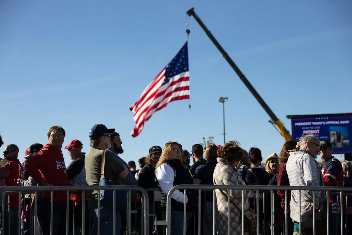 Peopel stand in line to attend a campaign rally on the eve of the US midterm elections, in Vandalia, Ohio, on Nov 7, 2022.