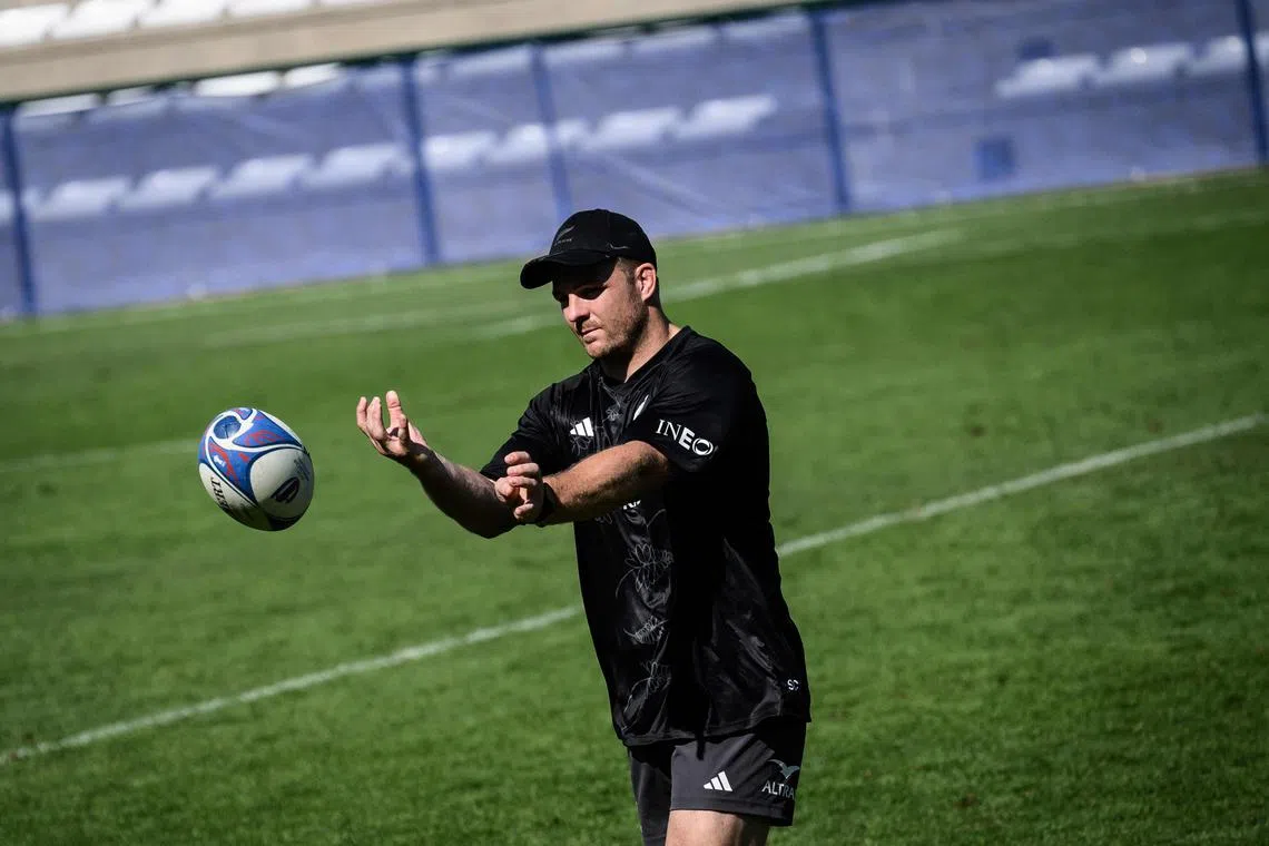 New Zealand flanker Sam Cane passes the ball during a training session in Lyon.