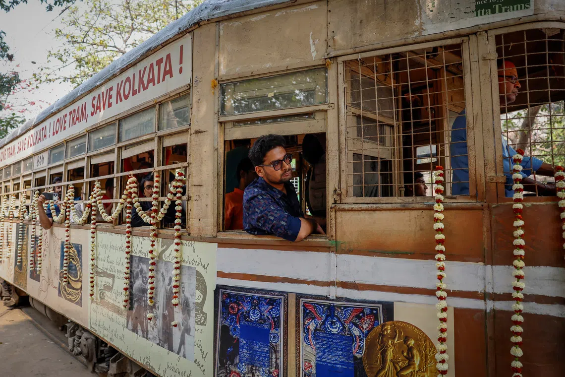 Passengers sit inside a decorated tram during the 152nd anniversary celebrations of trams in Kolkata, India, February 24, 2025. REUTERS/Sahiba Chawdhary