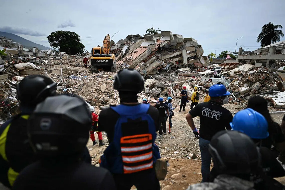 Rescuers carry out sound tests in search of survivors following the June 24 twin earthquakes, in Caraballeda, La Guaira state, Venezuela, on June 30.