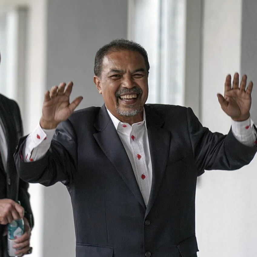 Malaysian former minister Jamil Khir Baharom (middle) claimed trial to a case involving pilgrim fund Tabung Haji.