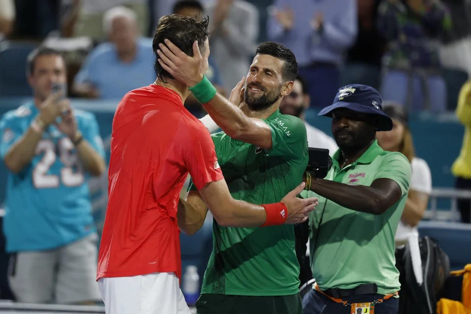 Mar 30, 2025; Miami, FL, USA; Jakub Mensik (CZE)(L) hugs Novak Djokovic (SRB)(R) after their men's singles championship of the Miami Open at Hard Rock Stadium. Mandatory Credit: Geoff Burke-Imagn Images