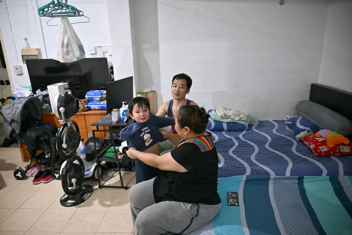 Ms Choo Chang Yan, 41, Grab driver, with her husband, Mr Zhao Wenbin, 35, technician, and their son, Zaleb Zhao Lee, 4, at their place on Nov 15, 2024.