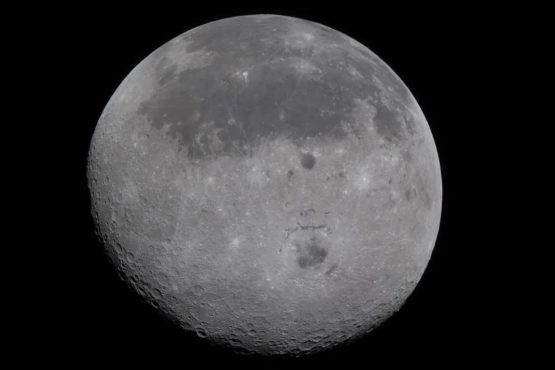 This handout image released by NASA shows a fully illuminated Moon, with the near side at top, dark lava plains, and the Orientale basin, with parts of the far side visible, on April 6, 2026. The four astronauts embarking on NASA's lunar flyby became on April 6 the humans to travel furthest from our planet, as they get set to view areas of the Moon never before seen by the naked eye. The Artemis II team broke the previous record set by 1970's Apollo 13 mission, which they are expected to surpass by approximately 4,105 miles (6,606 kilometers) when they reach this journey's anticipated furthest distance from Earth -- 252,760 miles (406,778 kilometers) -- later today. (Photo by Handout / NASA / AFP) / RESTRICTED TO EDITORIAL USE - MANDATORY CREDIT "AFP PHOTO / NASA" - HANDOUT - NO MARKETING NO ADVERTISING CAMPAIGNS - DISTRIBUTED AS A SERVICE TO CLIENTS