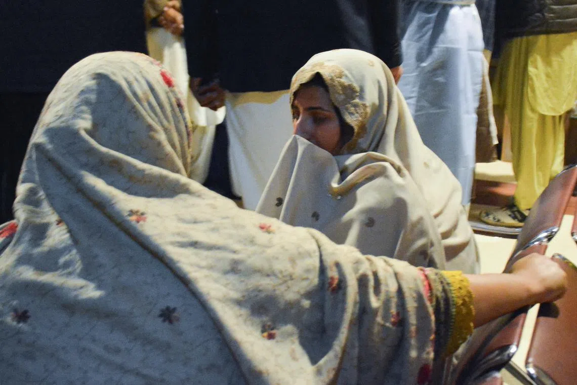 Passengers who were rescued from a train after it was attacked by separatist militants, sit at the Railway Station in Quetta, Balochistan, Pakistan, March 12, 2025. REUTERS/Stringer