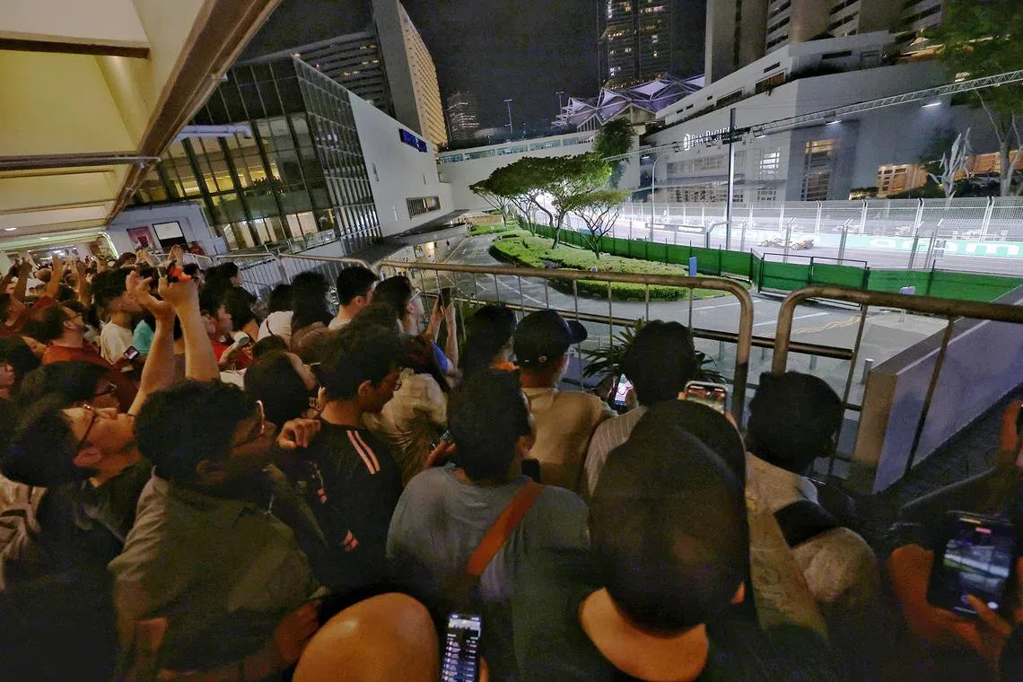 Fans watching McLaren's Lando Norris in action during the Singapore Airlines Singapore Grand Prix from an area outside Marina Square on Sept 22, 2024. 