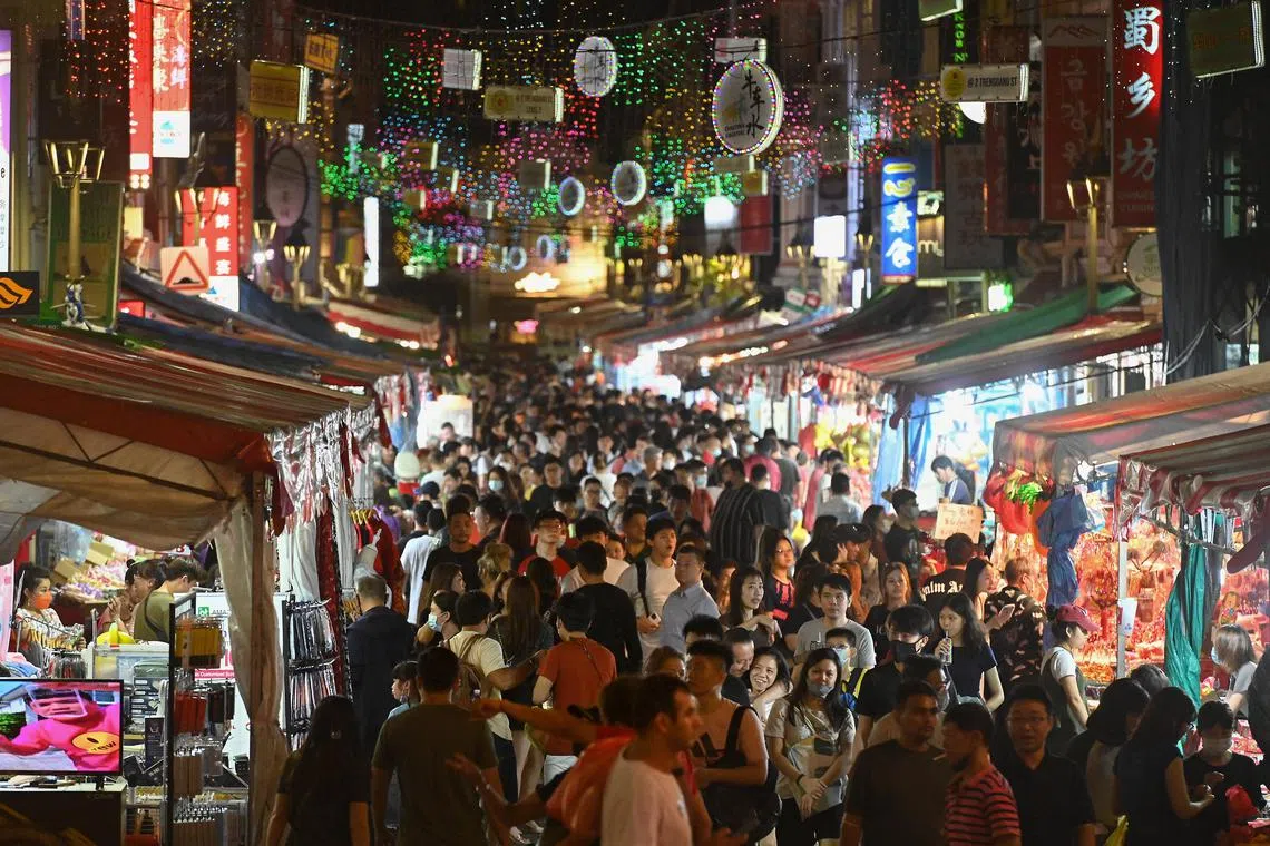 Pixgeneric / generic picture of shoppers along Crowded Temple Street on 15 Jan 2023 , Sunday night .Those who want to head over to the Chinese New Year bazaar in Chinatown are advised to check online for crowd levels before doing so. Large crowds are expected at the bazaar held from Jan. 1 to 21 after a two-year hiatus due to the Covid-19 pandemic. The police issued an advisory on Jan. 12. Diversions to access the bazaar may be implemented to ensure crowd safety, the police said. Specific areas will be locked down if crowd safety thresholds are reached. The police said members of the public should not attempt to force their way into crowded or closed-off areas and to follow the instructions of officers. The public is advised to check the Crowd@Chinatown map if they plan to visit between Jan 13 and 15, as well as between Jan 20 and 21, police said.