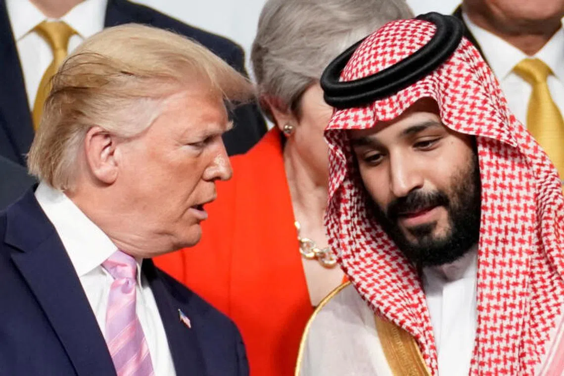 FILE PHOTO: U.S. President Donald Trump speaks with Saudi Arabia's Crown Prince Mohammed bin Salman during family photo session with other leaders and attendees at the G20 leaders summit in Osaka, Japan, June 28, 2019. REUTERS/Kevin Lamarque/File Photo