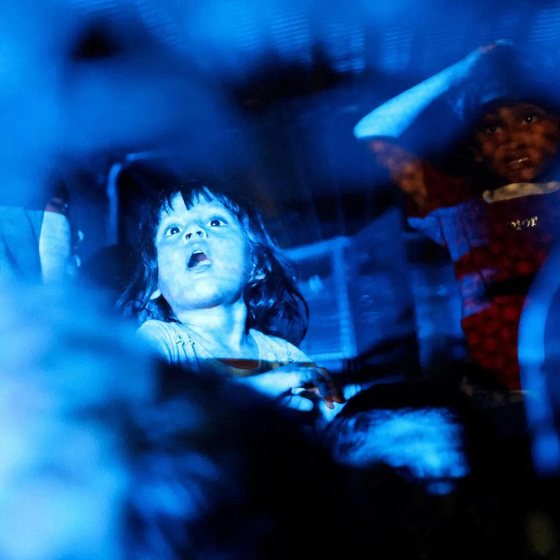 Rohingya refugees sit inside a truck as they are taken by police in front of the office of the U.N. Refugee Agency after being evicted from their homes, at Kuala Lumpur Malaysia July 27, 2026. REUTERS/Hasnoor Hussain      TPX IMAGES OF THE DAY     