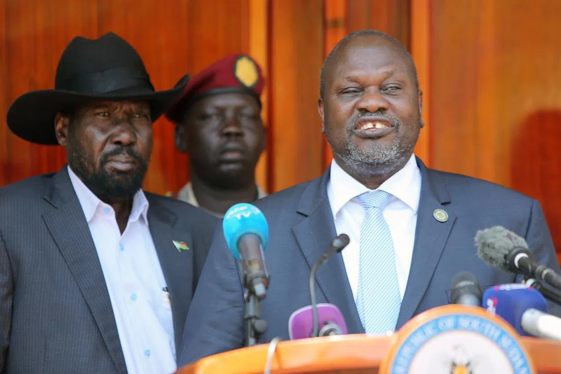 South Sudan's ex-vice President and former rebel leader Riek Machar flanked by President Salva Kiir Mayardit address a news conference at the State House in Juba, South Sudan February 20, 2020. REUTERS/Jok Solomun/File Photo