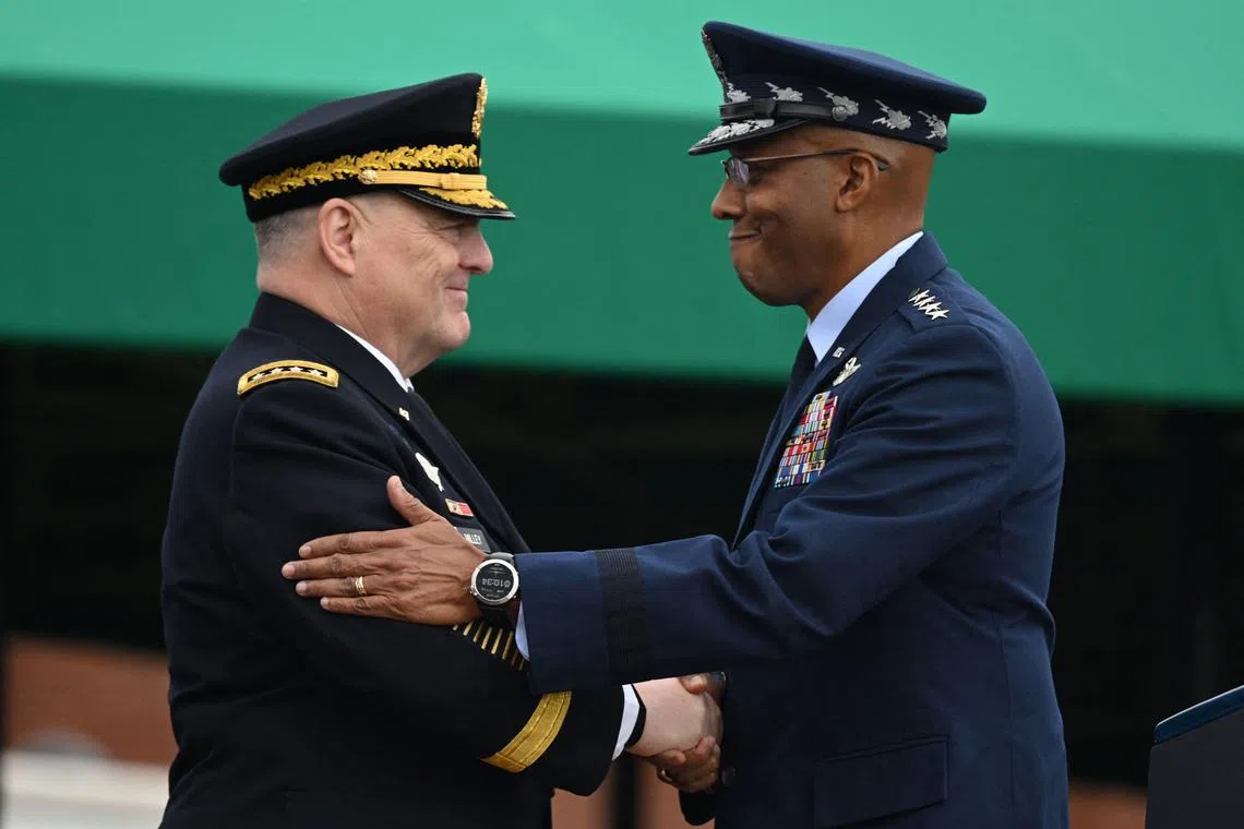 Retiring Gen Milley (left) greets incoming chairman of the Joint Chiefs of Staff, General Charles Brown.