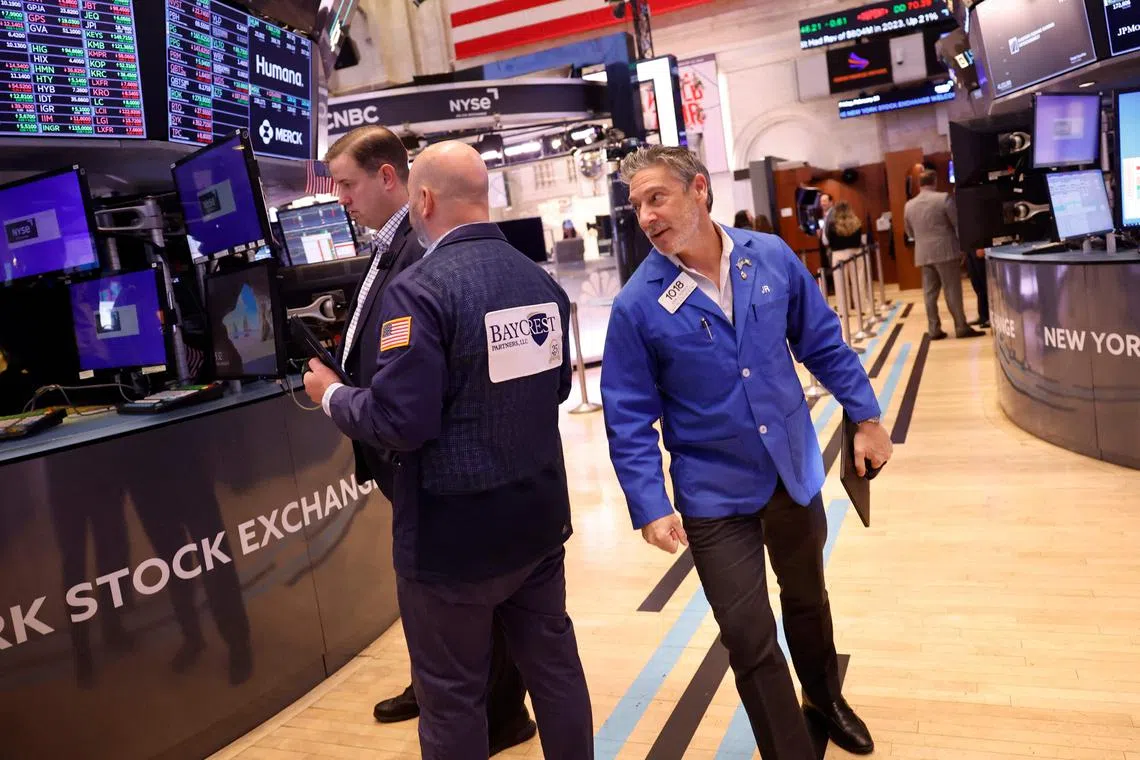 Traders work on the floor of the New York Stock Exchange, in New York City.