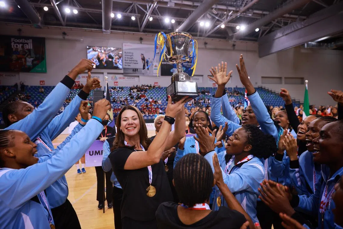 Botswana coach Jennifer van Dyk celebrates with her team after winning the Nations Cup