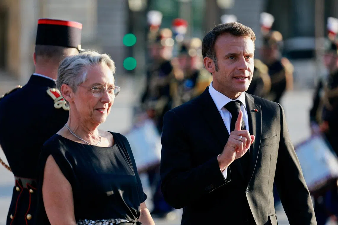 French President Emmanuel Macron has decided to keep Ms Elisabeth Borne (left) in her role as prime minister.