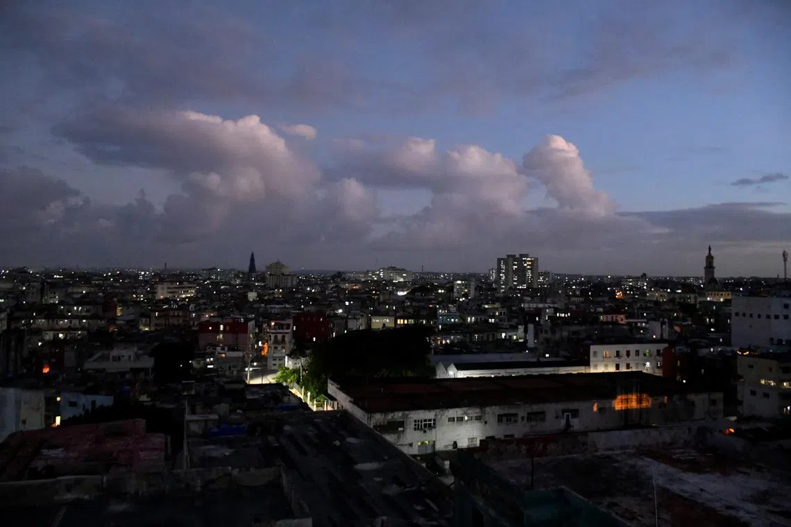 FILE PHOTO: Apartments and buildings are partially lit as Cuba makes fast progress restoring power to swaths of the Caribbean island nation, both in Havana and outlying provinces, after the entire national electrical grid crashed last Friday, in Havana, Cuba October 21, 2024. REUTERS/Norlys Perez/File Photo