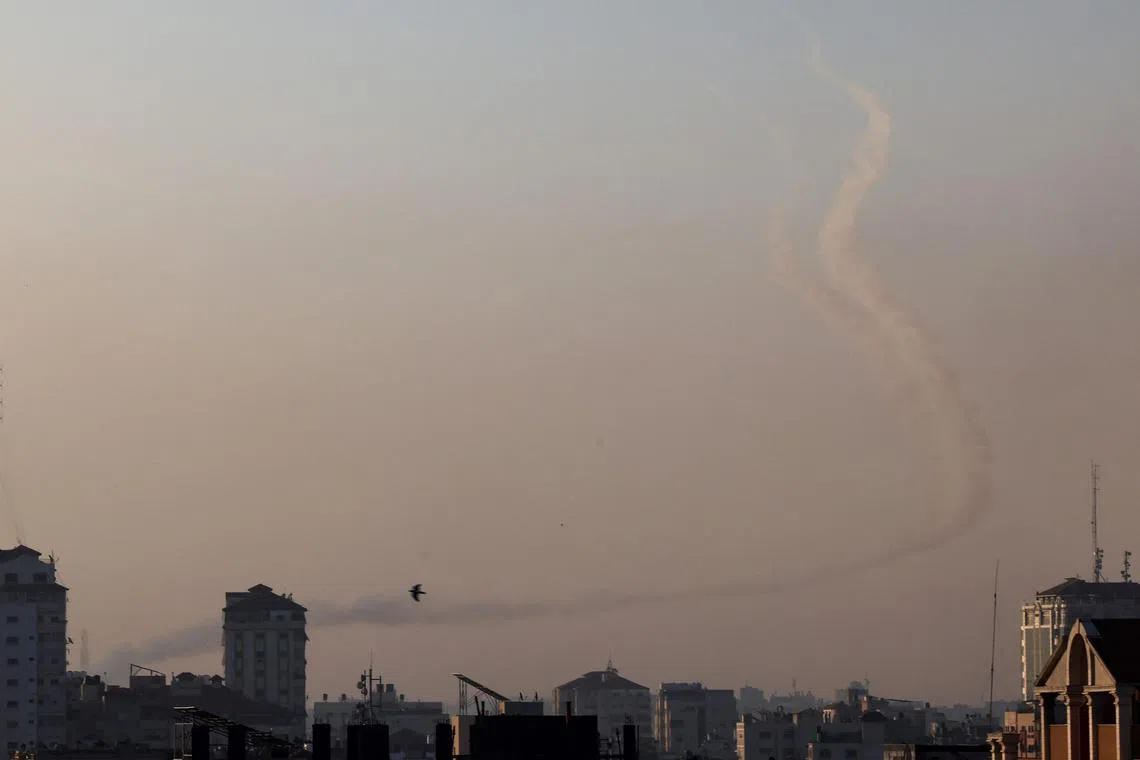 Trails of smoke are seen as rockets are fired from Gaza towards Israel, in Gaza City, on May 2, 2023. 