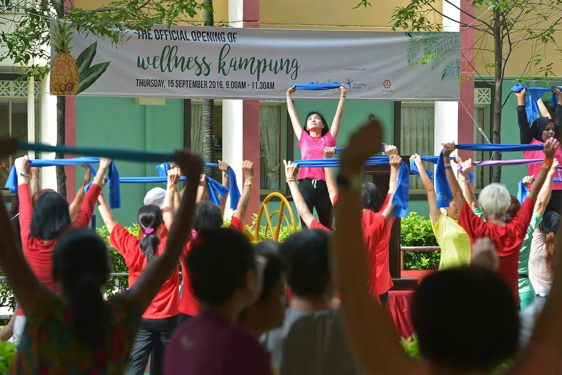 Residents joining a mass morning exercise during the official opening of a wellness kampung in Nee Soon Central in 2016.