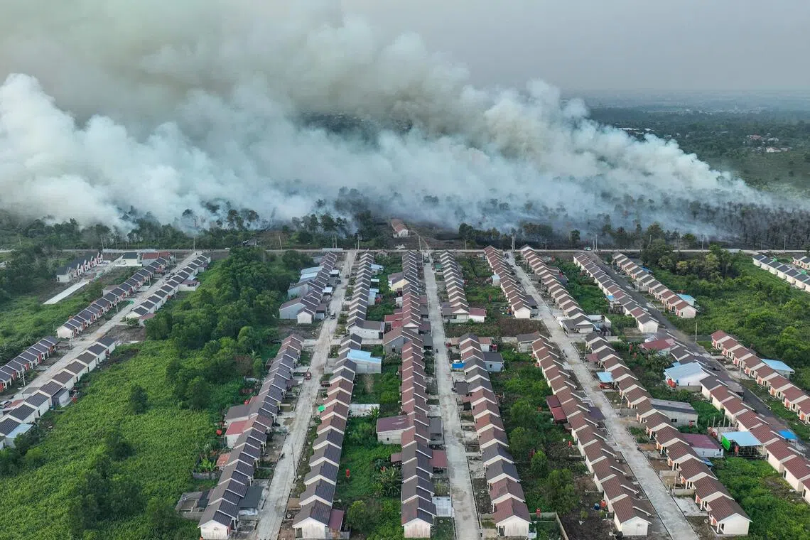 Smoke rising from a wildfire next to housing complex in Kubu Raya, West Kalimantan.