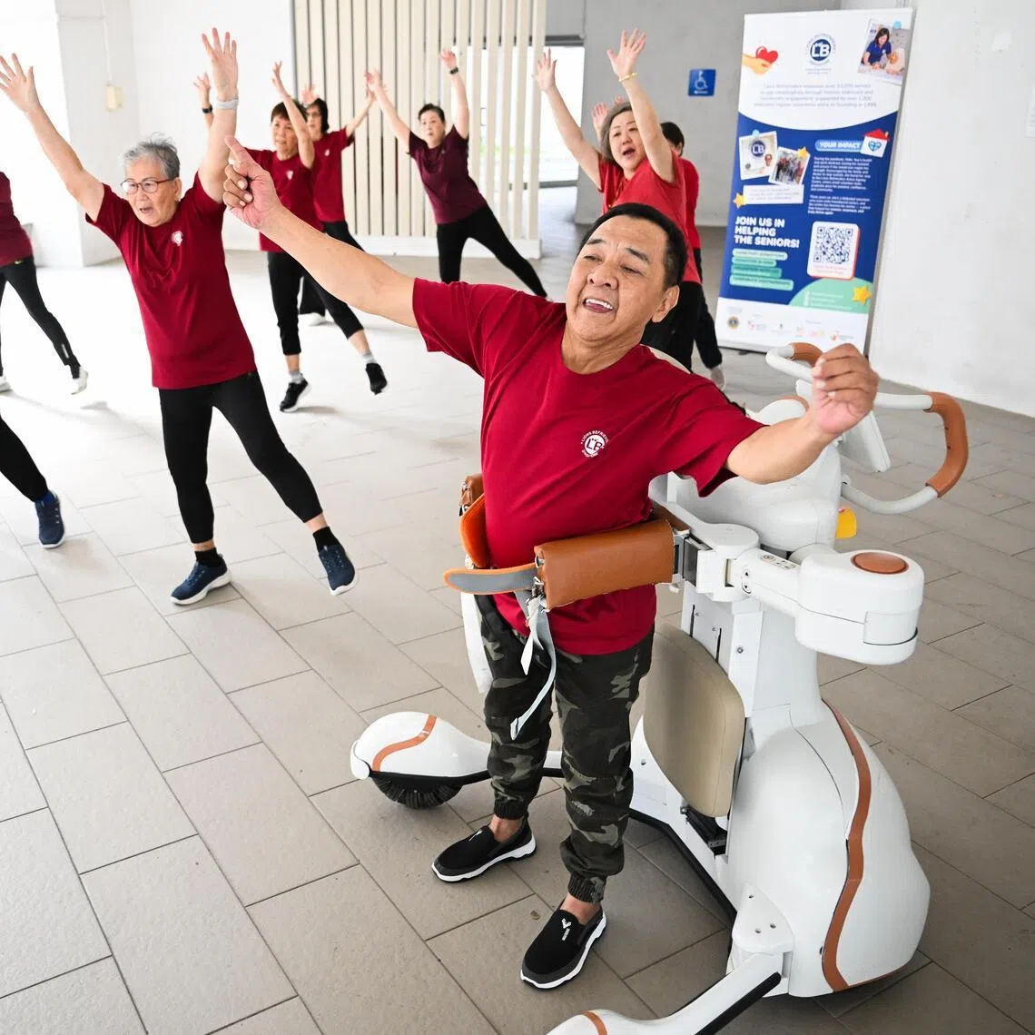 Stroke survivor Leow Cher Hwa (right), 66, using a wearable robot to exercise during a Zumba class at his active ageing centre in Tampines.