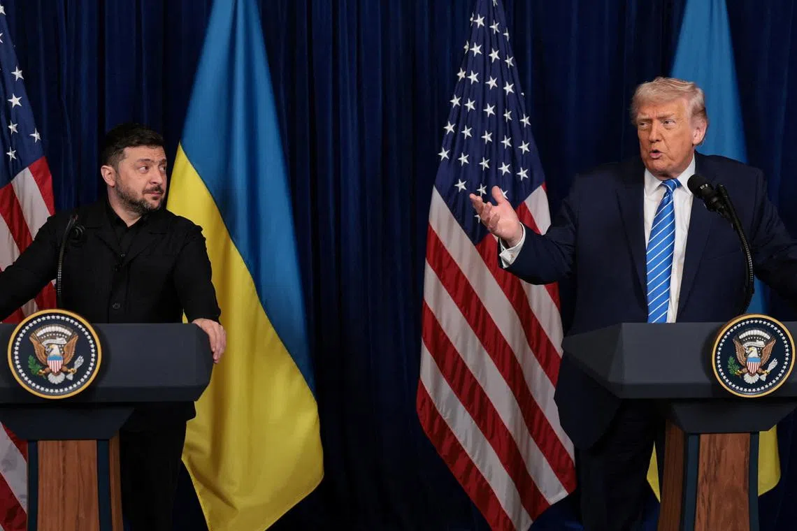 Ukrainian President Volodymyr Zelenskiy listens to U.S. President Donald Trump, after Trump said that Russian President Vladimir Putin expressed willingness to help Ukraine \"succeed\", during a press conference at Trump's Mar-a-Lago club, in Palm Beach, Florida, U.S., December 28, 2025. REUTERS/Jonathan Ernst