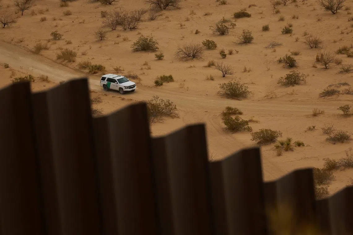FILE PHOTO: A U.S. Border Patrol vehicle conducts surveillance near a section of the U.S.-Mexico border wall, as seen from Ciudad Juarez, Mexico, March 27, 2025. REUTERS/Jose Luis Gonzalez/File Photo