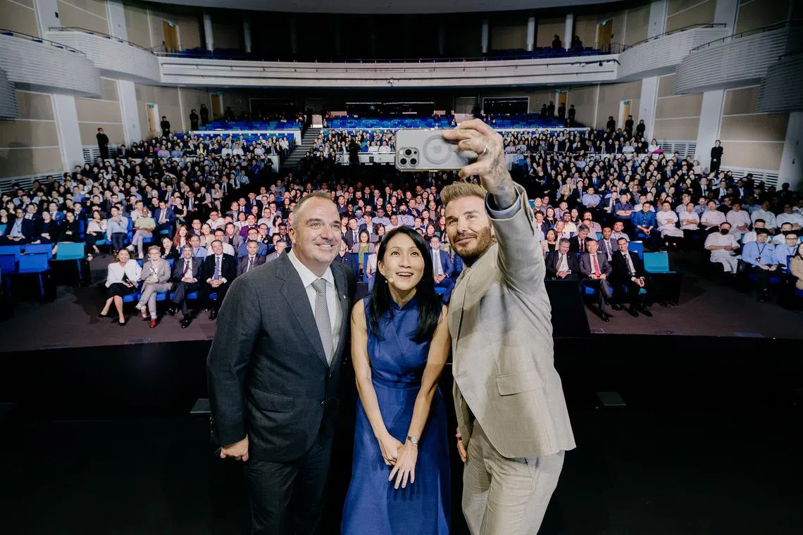 Sands Global Ambassador and retired footballer David Beckham taking a wefie with Marina Bay Sands' chief operating officer Paul Town and chief marketing officer Irene Lin.