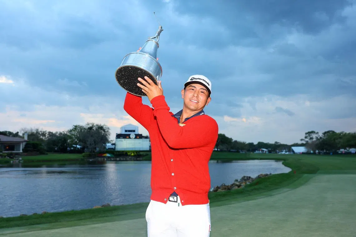 Kurt Kitayama of the United States celebrating with the trophy after winning the Arnold Palmer Invitational at Arnold Palmer Bay Hill Golf Course in Orlando, Florida. 