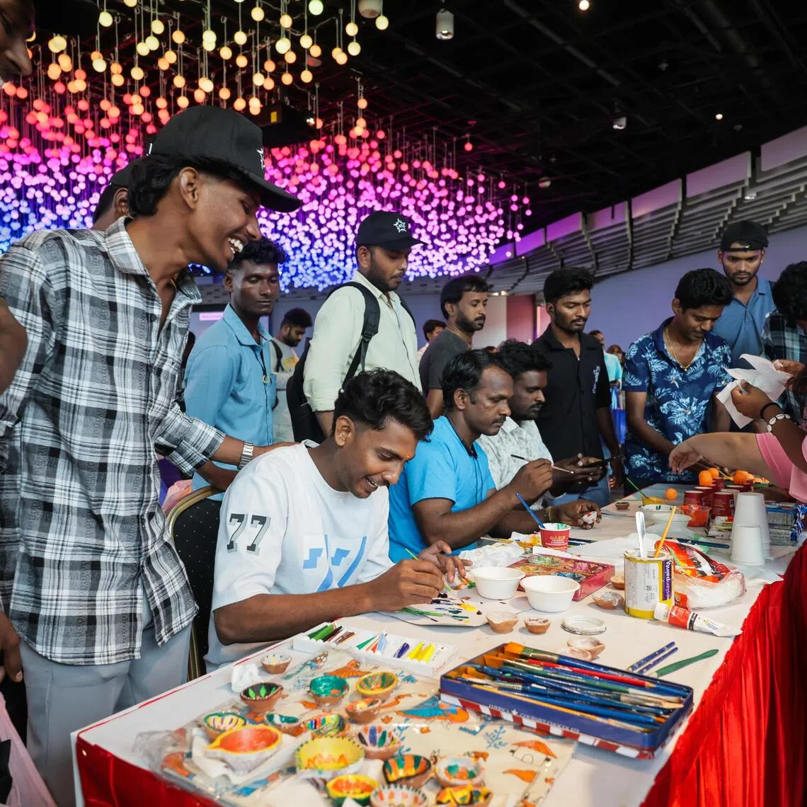 Migrants workers participating in games and other activities at the Deepavali celebrations event held at Gardens by the Bay.