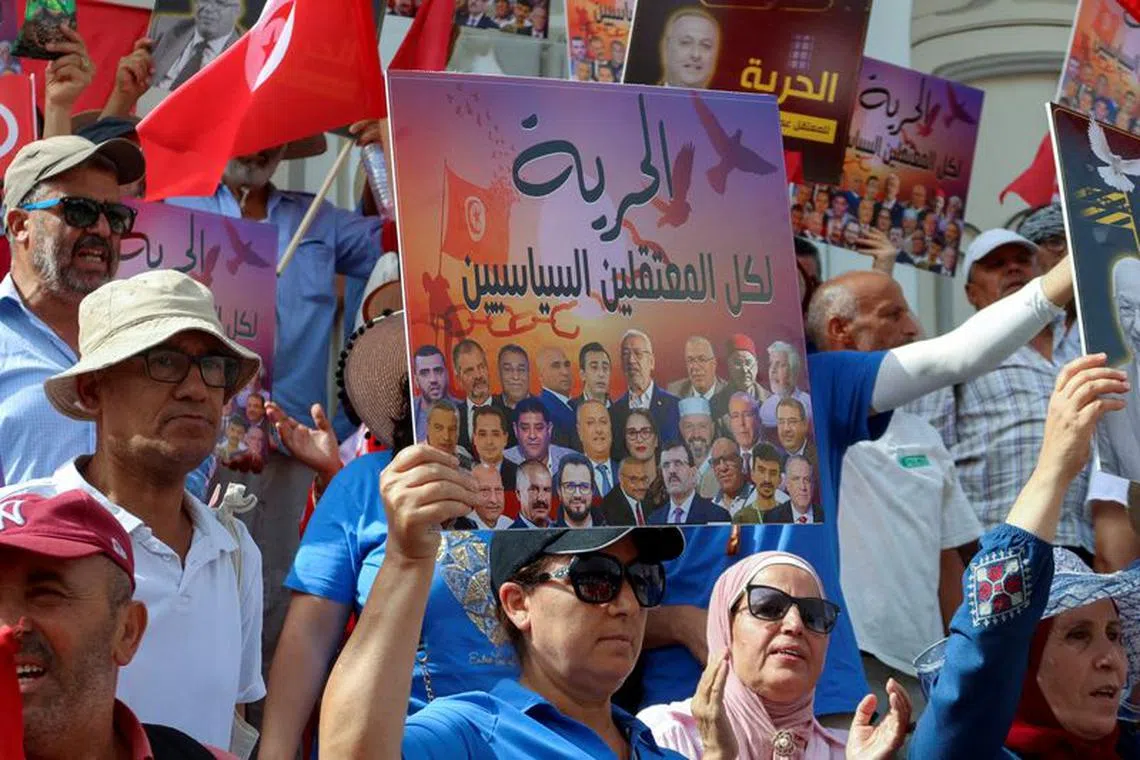 FILE PHOTO: Supporters of Tunisia's Salvation Front opposition coalition carry banners and flags during a protest against Tunisia's President Kais Saied, marking two years since Saied began amassing power, amidst a heatwave in Tunis, Tunisia  July 25, 2023. REUTERS/Jihed Abidellaoui/File Photo
