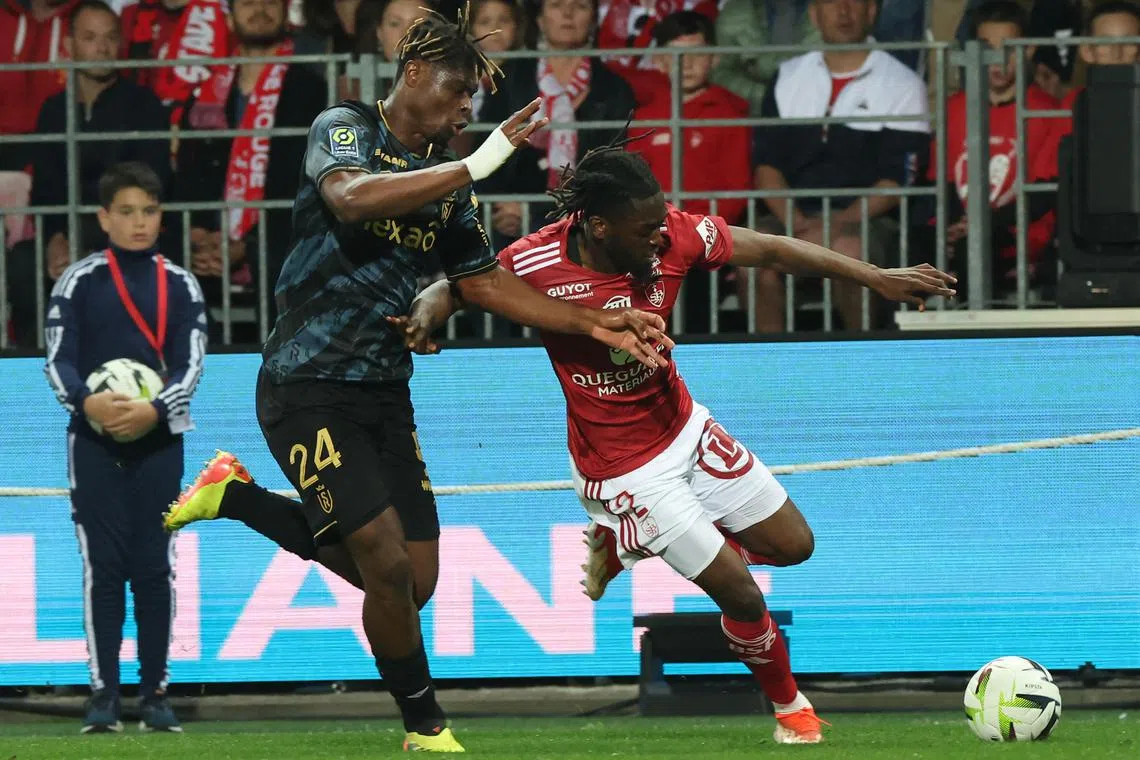 Reims' Emmanuel Agbadou (left) challenging Brest's Bradley Locko  in their French Ligue 1  match at Stade Francis-Le Ble on May 10, 2024. 